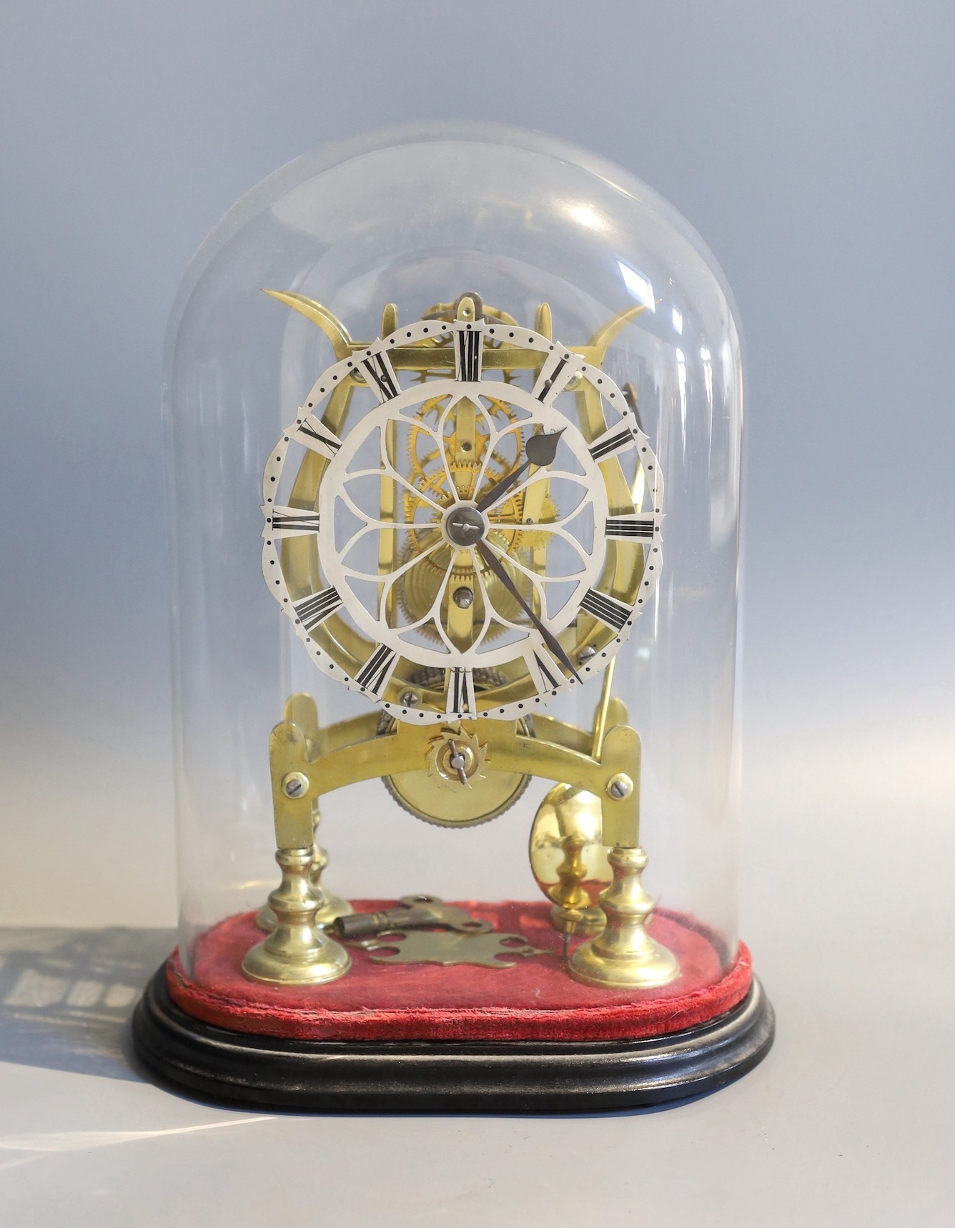 A 19th century brass skeleton mantel timepiece, under glass dome, with single fusee movement and pierced silvered chapter ring, height 24cm